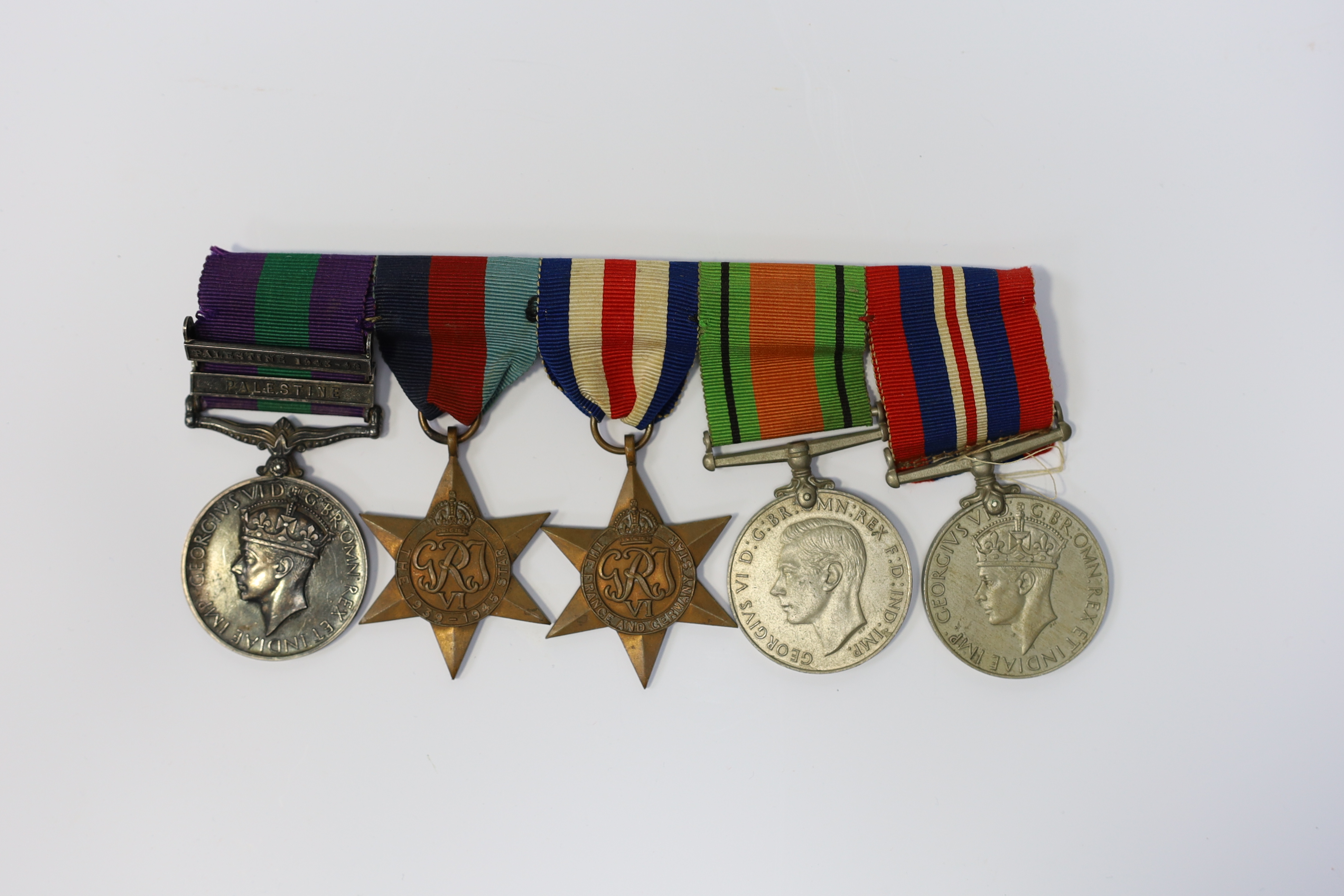 A WWII medal group awarded to Pte. J. Langridge S. Staff, comprising; a General Service Medal with two bars for Palestine and Palestine 1945-48, stamped to the edge with the recipient’s details, together with a 1939-45 S